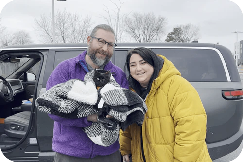 Happy family with their Cavalier puppy